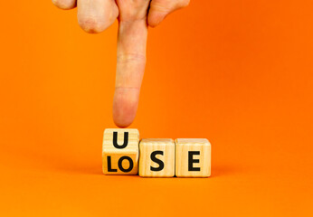 Use or lose symbol. Concept words Use or lose on wooden cubes. Businessman hand. Beautiful orange table orange background. Business Use or lose concept. Copy space. - obrazy, fototapety, plakaty