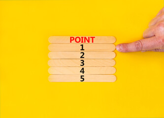 Time to point 1 symbol. Concept word Point 1 2 3 4 5 on wooden sticks. Businessman hand. Beautiful yellow table yellow background. Business planning and time to point 1 concept. Copy space.