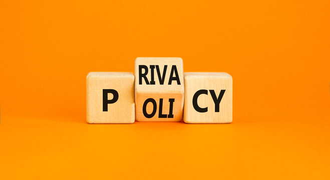 Privacy policy symbol. Concept words Privacy policy on wooden block on a beautiful orange table orange background. Business and privacy policy concept. Copy space.
