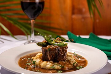 Delicious meal of juicy meat in a flavorful gravy served over a bed of fresh mashed potatoes