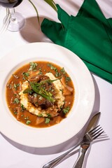 Delicious meal of juicy meat in a flavorful gravy served over a bed of fresh mashed potatoes