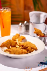 Child's meal of chicken tenders, french fries, and ketchup, with colorful crayons on the table