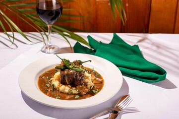 Delicious meal of juicy meat in a flavorful gravy served over a bed of fresh mashed potatoes