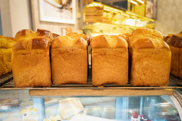 fresh pastries on the counter in the store. Breads with a golden crust. Loaves of bread assortment....