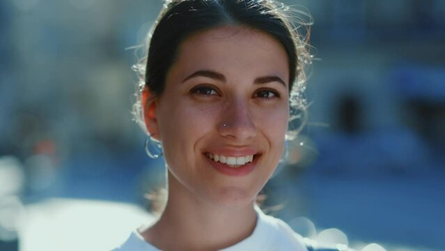 Smiling young Caucasian woman with a nose piercing