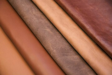 Array of leather fabric samples in different shades neatly placed on a table, ready to be crafted
