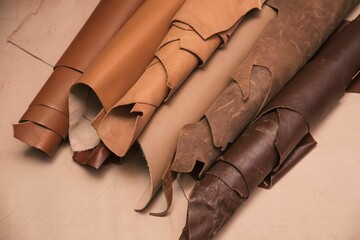 Array of leather fabric samples in different shades neatly placed on a table, ready to be crafted
