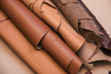 Array of leather fabric samples in different shades neatly placed on a table, ready to be crafted