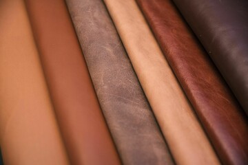 Array of leather fabric samples in different shades neatly placed on a table, ready to be crafted