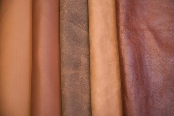 Array of leather fabric samples in different shades neatly placed on a table, ready to be crafted