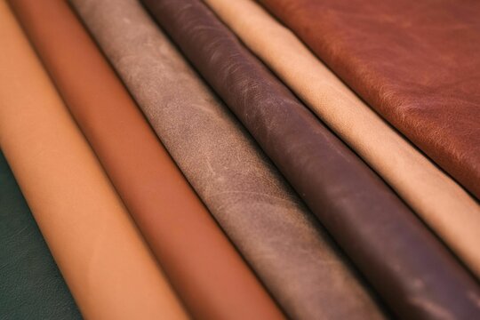 Array of leather fabric samples in different shades neatly placed on a table, ready to be crafted
