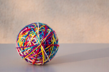 a ball of woolen threads of different colors. - 628960388