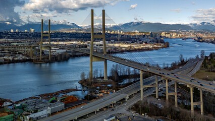 Aerial view of the Alex Fraser Bridge, with its long, arching over the Fraser River