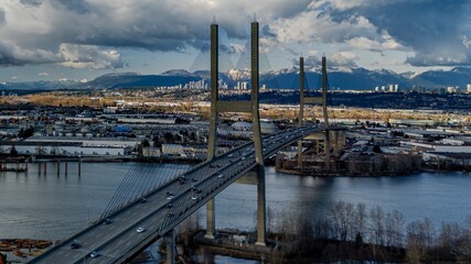 Aerial view of the Alex Fraser Bridge, with its long, arching over the Fraser River