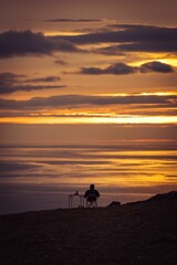 a person admires the sunset at the north cape