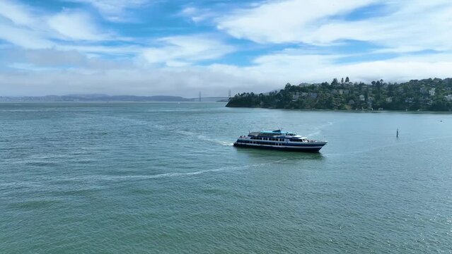 Aerial video outside Tiburon with yacht sailing across water