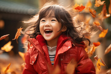 close up of little asian girl child playing in autumn fall leaves red jacket - Powered by Adobe