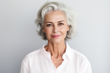 Fototapeta premium Portrait of Smiling confident stylish mature middle aged woman standing at home office. Old senior businesswoman, 60s gray-haired lady executive business leader manager looking at camera . High