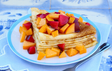 Stack of triangle crepes with fruits