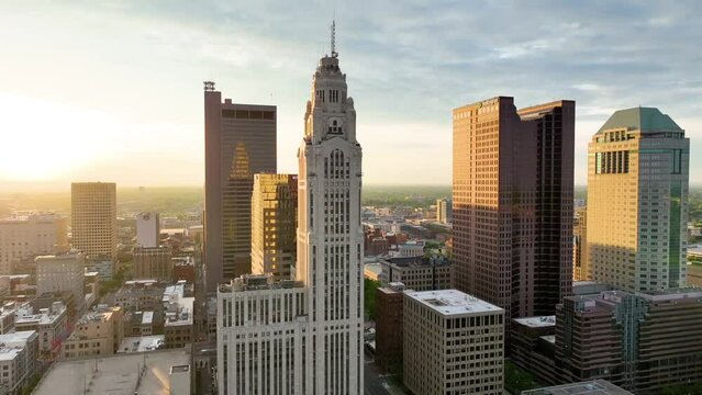 Aerial video close up of main Columbus skyscrapers with sunrise hitting side of buildings