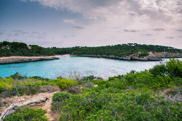 Beautiful sunset beach landscape, exotic tropical island nature, blue sea water, ocean waves, colorful red yellow sky, summer holidays vacation in Mallorca, Spain