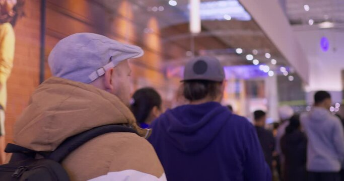 Queue of people waiting line for service. Dynamic video of queue of people standing in shopping mall at evening. Visit shopping mall at day time to avoid queue of people or make online shopping.