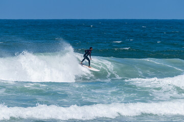 Surfer riding waves in Furadouro Beach