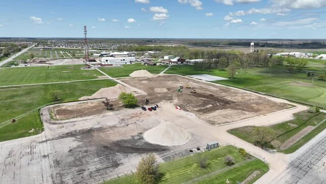 Byron Health Center in springtime aerial video of nearly empty lot with refined rubble piles