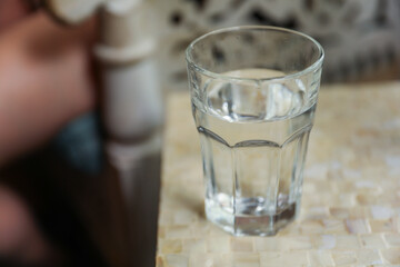 glass cup on a table, symbolizing clarity, transparency, and receptivity to new ideas and perspectives. Metaphor for openness