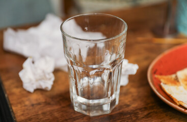 glass cup on a table, symbolizing clarity, transparency, and receptivity to new ideas and perspectives. Metaphor for openness