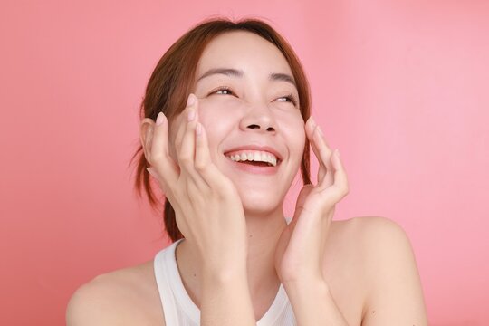 Beautiful Asian Woman Applying Serum On Face, Portrait Beautiful Asian Woman In Nature Makeup With Smiling Face.