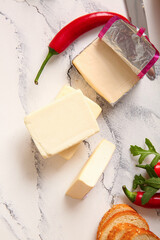 Processed cheese with bread and vegetables on grunge background