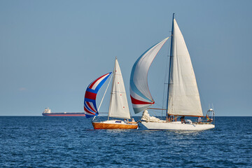 Sailing yacht regatta. Many sailing yachts in a row. sailing yachts under gennaker, speaker, genoa