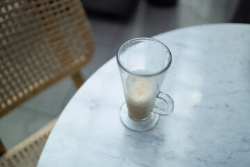 a half-drunk flat white coffee on a concrete table at city cafe. High quality photo
