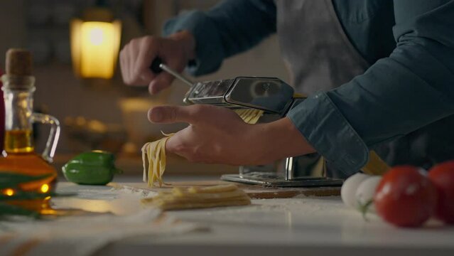 Food, Young white housewife A manual machine rolls dough into a thin sheet in a pasta laboratory. In slow motion Pasta Cooker. follows the modern principles of healthy food, handmade