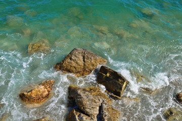 Turquoise sea water and rocks in shallow water