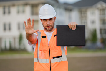 Builder with stop gesture, no hand, dangerous on building concept. Portrait of builder man. Construction worker with hardhat helmet.