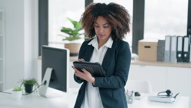 Video of elegant business woman working  with digital tablet at modern office