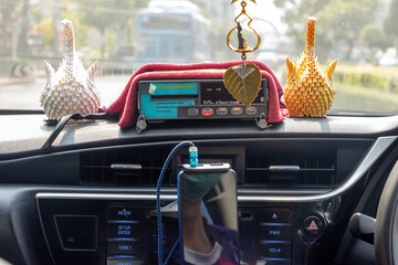 The dashboard of taxi with the digital taxi meters while moving car on a city street, Bangkok, Thailand