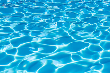 Fototapeta na wymiar Vibrant blue water surface with captivating sunlit reflections, closeup view of a swimming pool