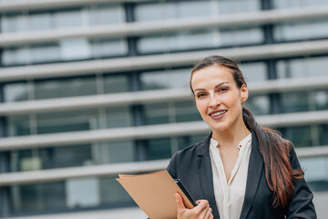 outdoor portrait of business woman with documents