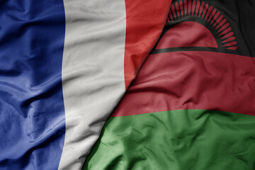 Obraz premium big waving realistic national colorful flag of france and national flag of malawi .
