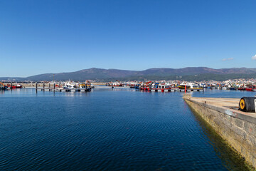 Fototapeta na wymiar Small pier of the fishing village of Cabo de Cruz. A Coruña, Galicia, Spain.