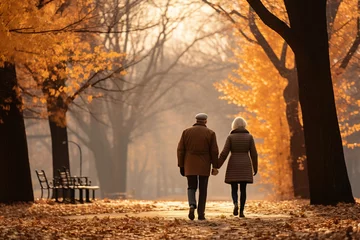 Zelfklevend Fotobehang couple walking in autumn park © PerOlav