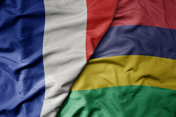 big waving realistic national colorful flag of france and national flag of mauritius .