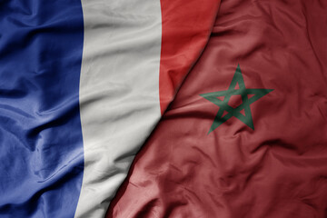 big waving realistic national colorful flag of france and national flag of morocco .