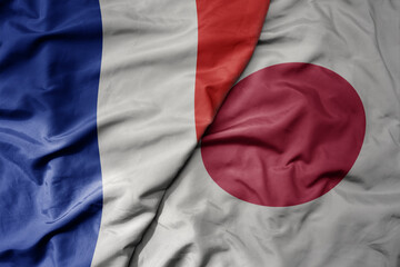 Fototapeta premium big waving realistic national colorful flag of france and national flag of japan .