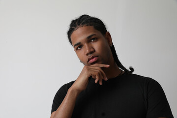 Obraz premium Portrait of handsome dark-skinned young man posing in the studio.Mock-up.