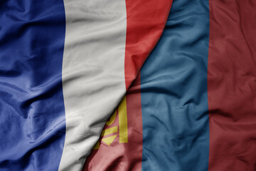 big waving realistic national colorful flag of france and national flag of mongolia .