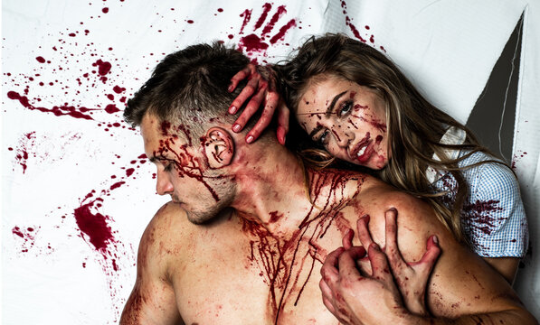 Strong man. Piece of meat. Butcher cutting meat. A terrible Halloween. Sexy woman vampire. Couple in blood.